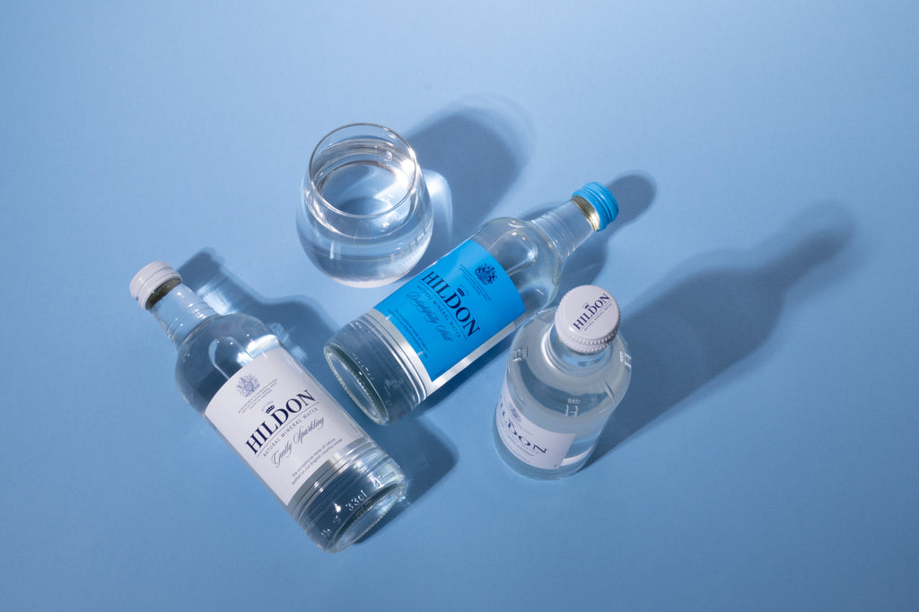 Hildon small glass bottles and branded glass  Photography by Serenpho